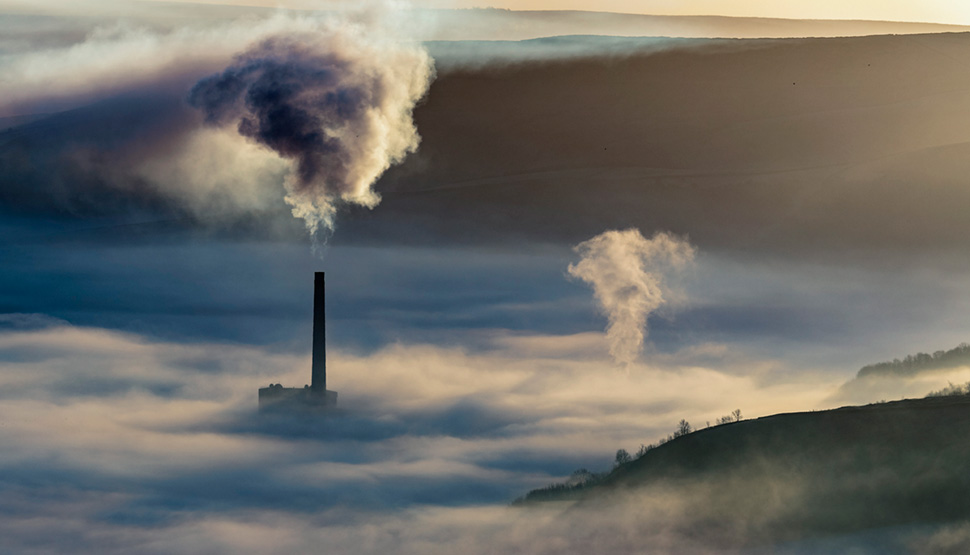 Smoke stack above the clouds